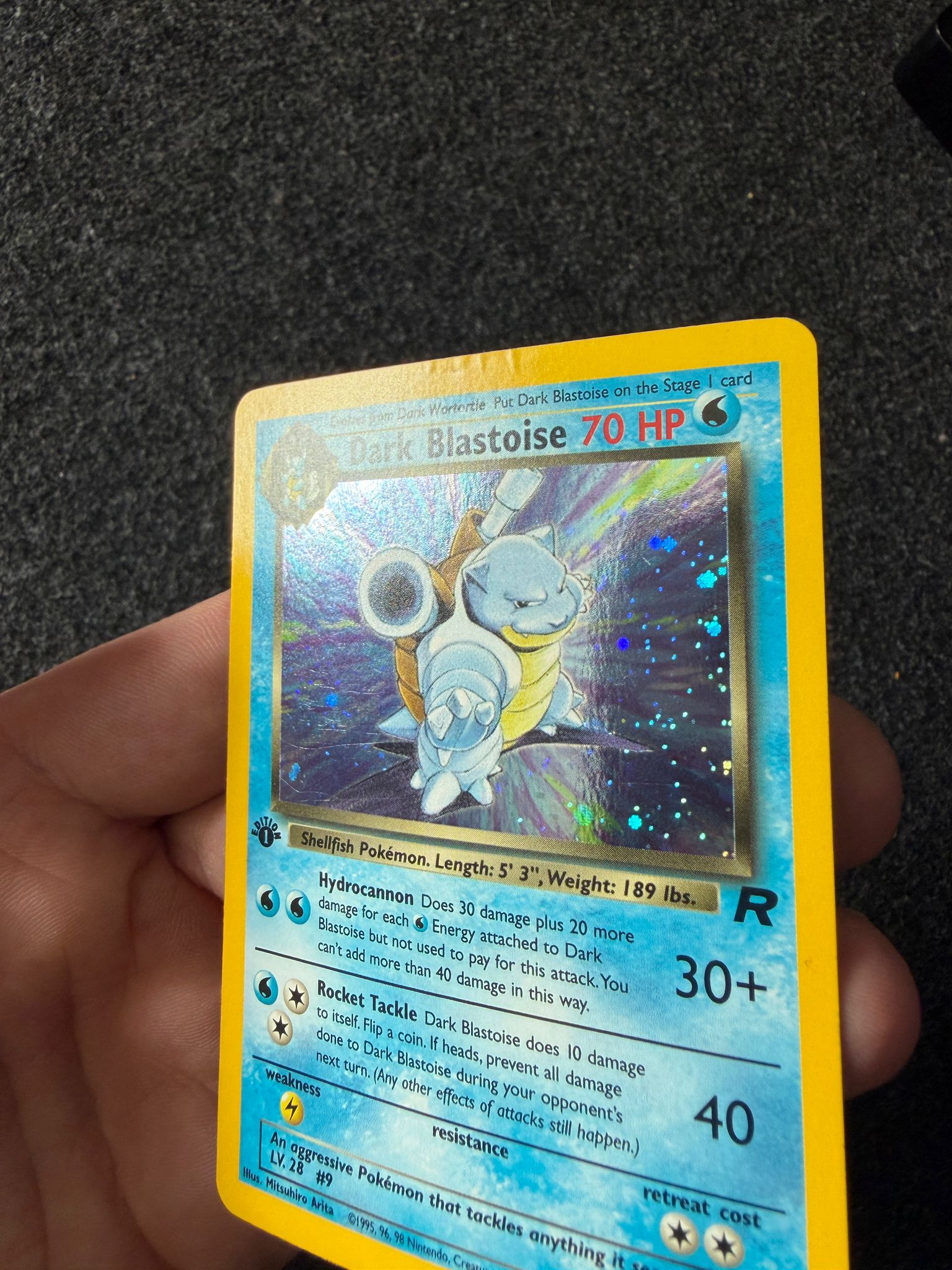 Dark Blastoise Pokémon trading card before restoration, with creasing visible along the top edge