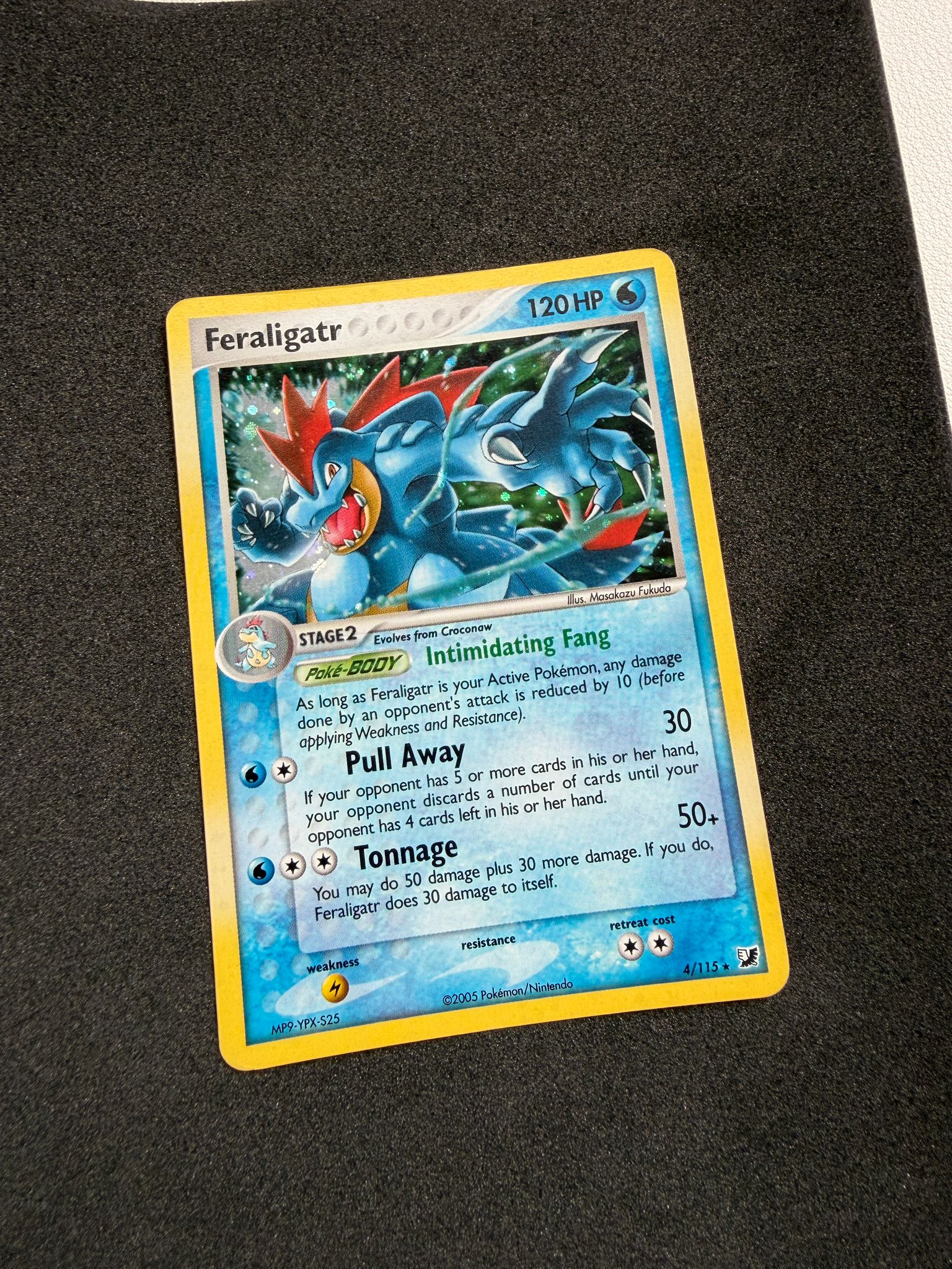 Feraligatr Pokémon trading card after restoration, showing the improved crease