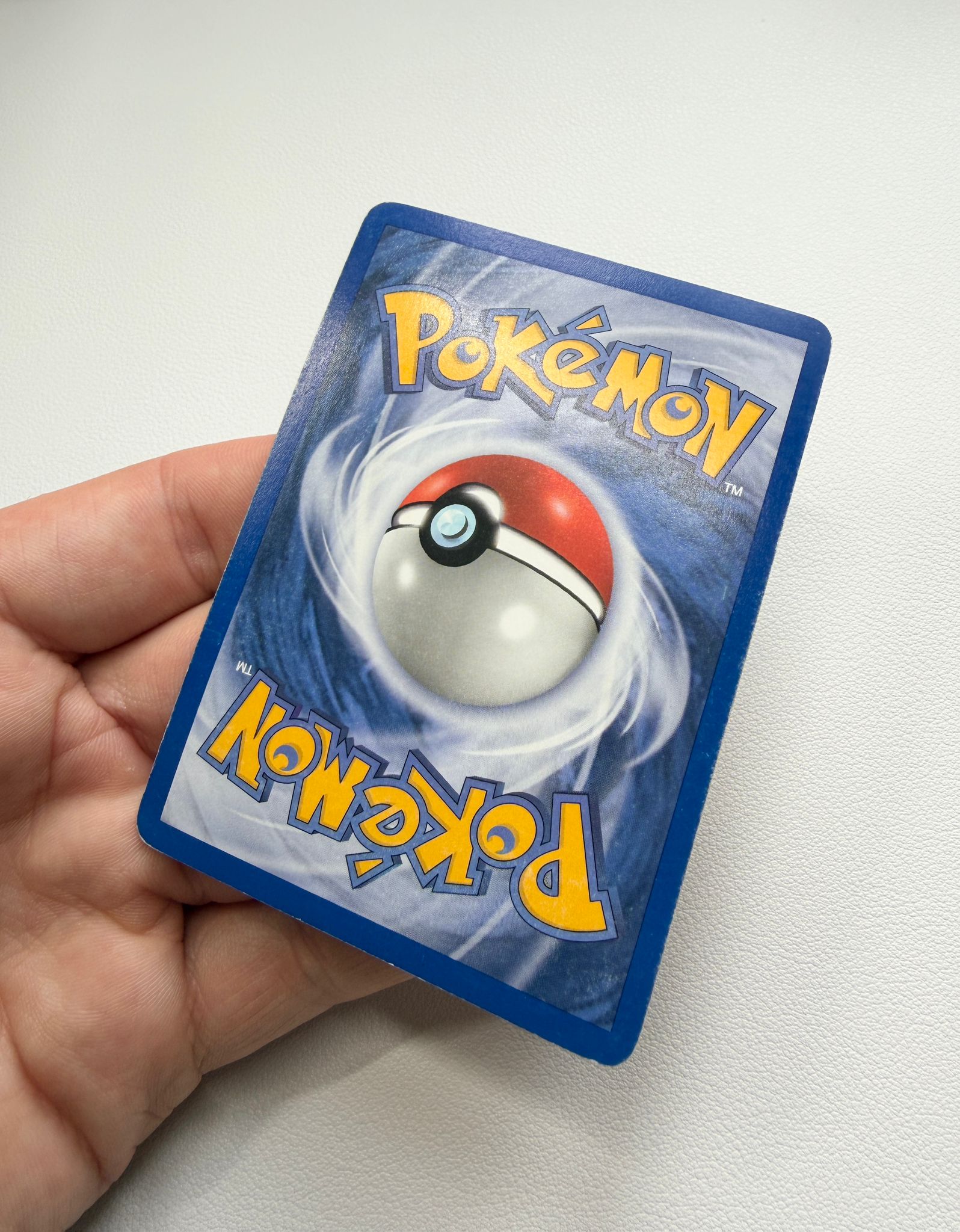 Pokémon trading card back after surface cleaning, showing the cleaner surface